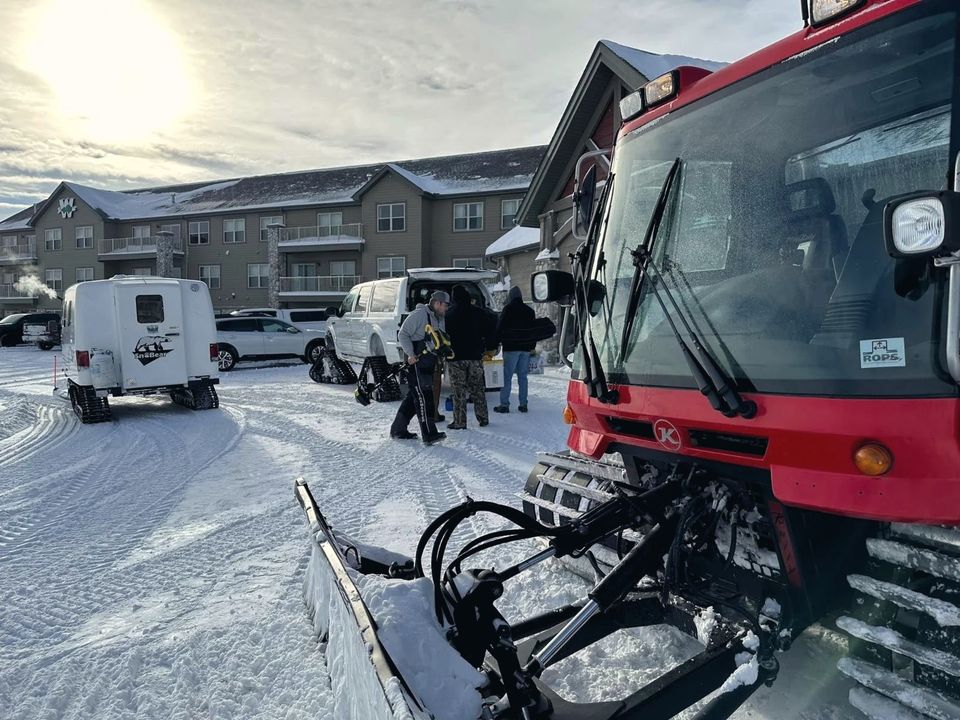 Woodland's ice crew with a snow groomer and plow outside the lodge