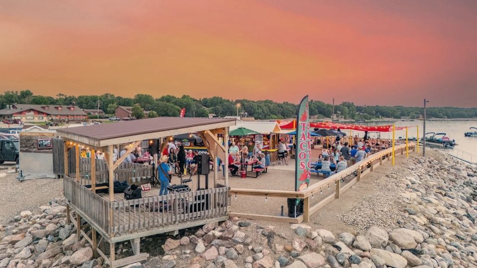 Guests on the lakeside deck at sunset