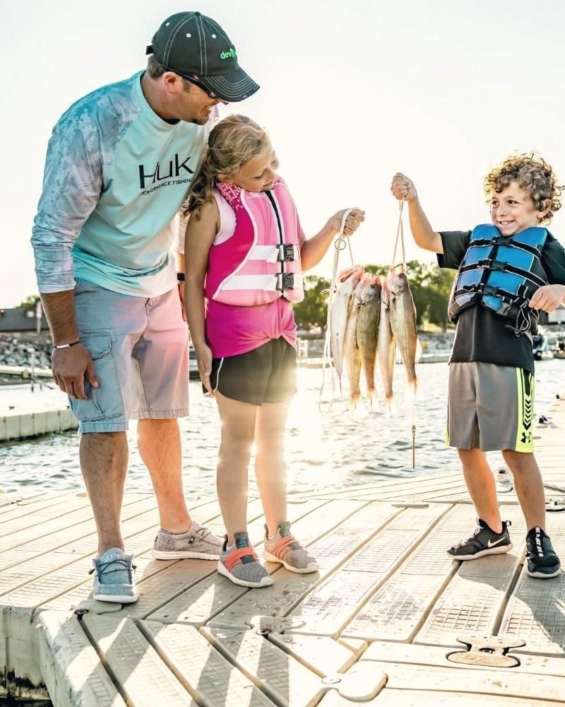 Family showing off walleye on the Woodland dock