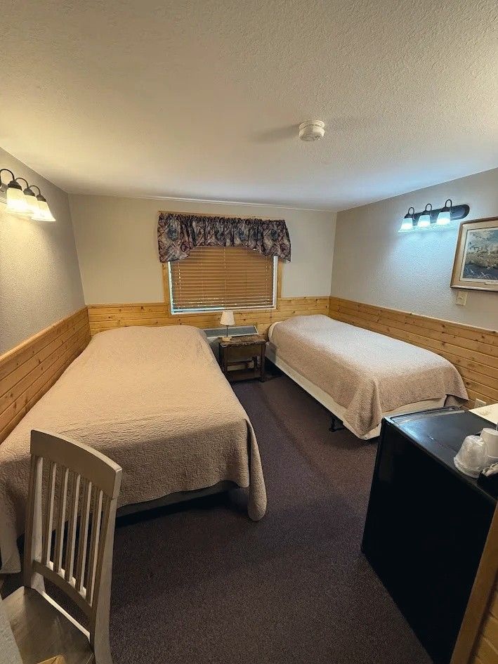 Motel room with a full bed and a twin bed