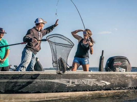 Perch Patrol guide netting a walleye for anglers