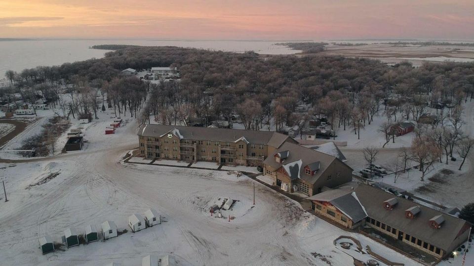 Aerial view of Woodland Resort and the frozen bay at sunset