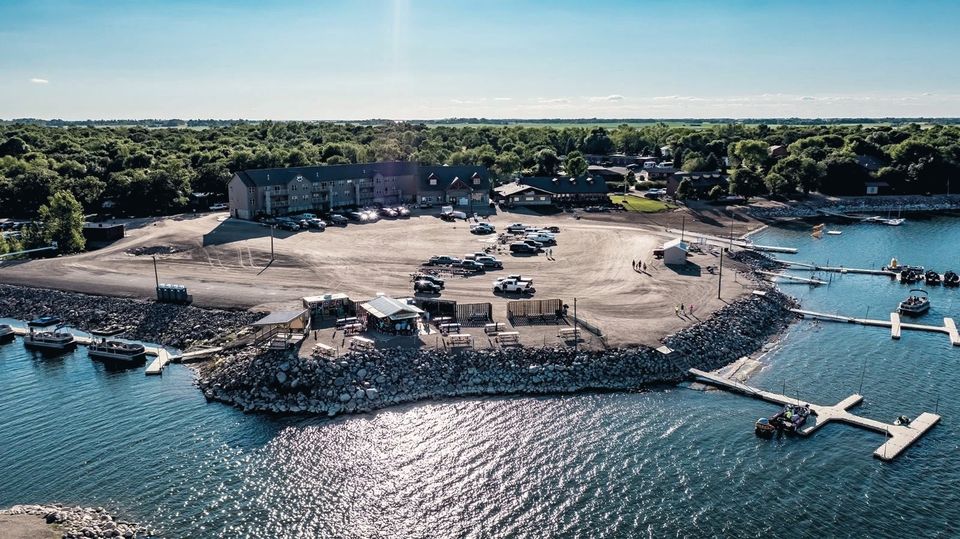 Aerial view of Woodland Resort's marina, boat ramp and docks on Devils Lake in summer